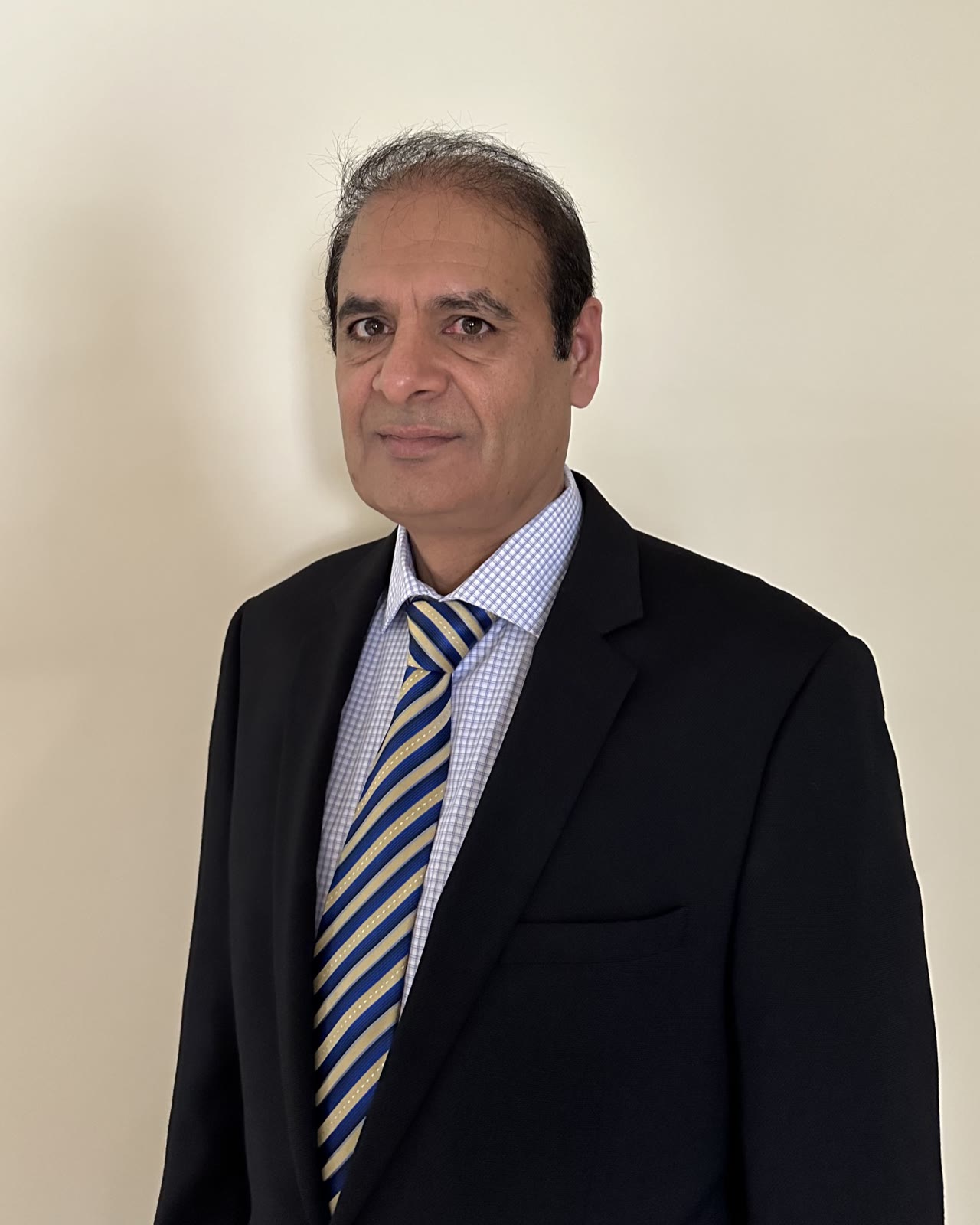 Shahid from Insurance Time in a professional broker portrait.